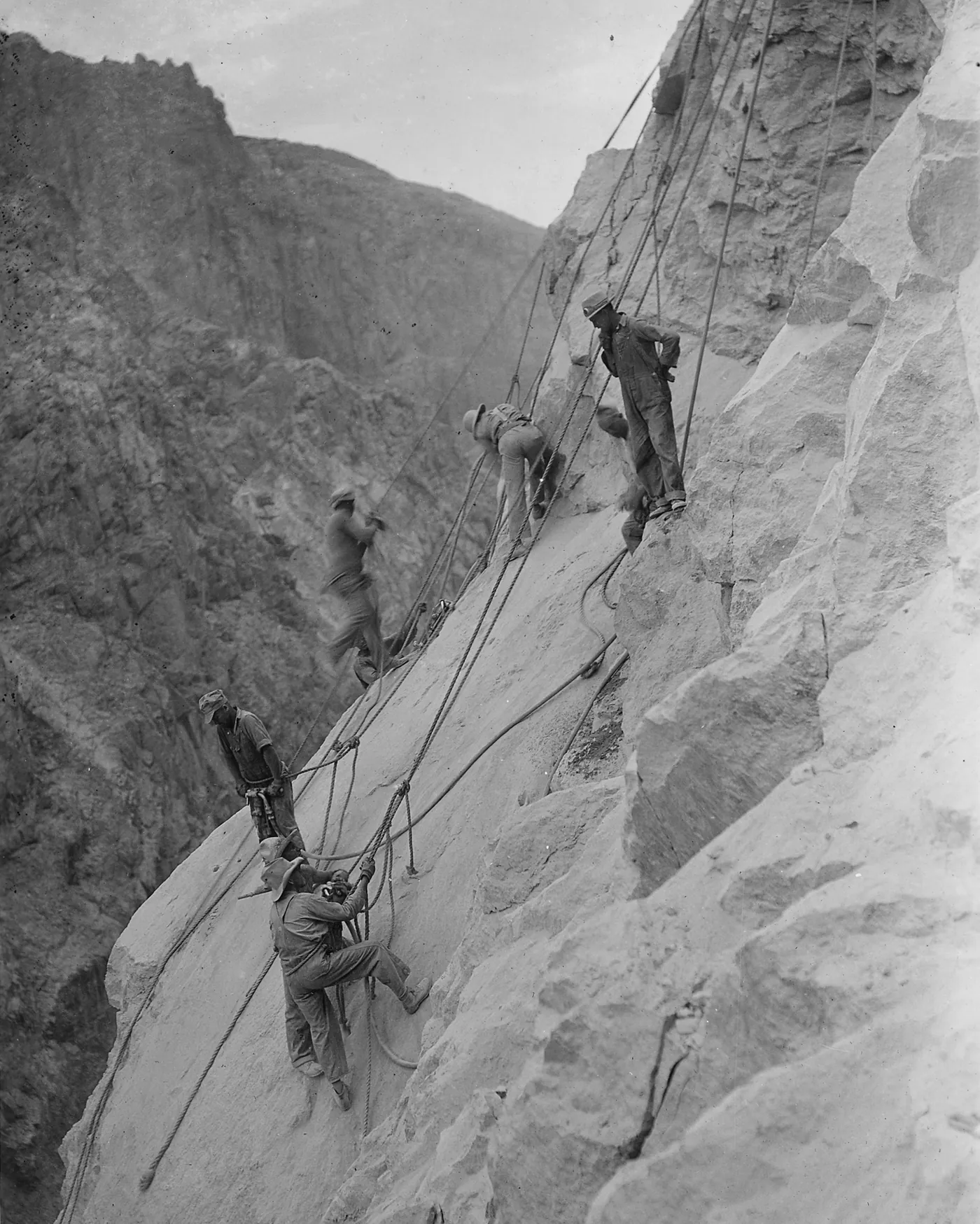 High-scalers on ropes working on the canyon wall at the Hoover Dam site